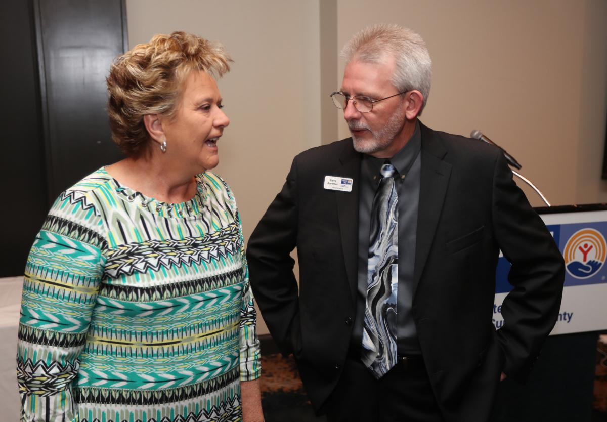 Elaine Broyles from HATS, a UWSC partner agency, talks with UWSC Executive Director Steve Doremus prior to the start of the Breakfast program.