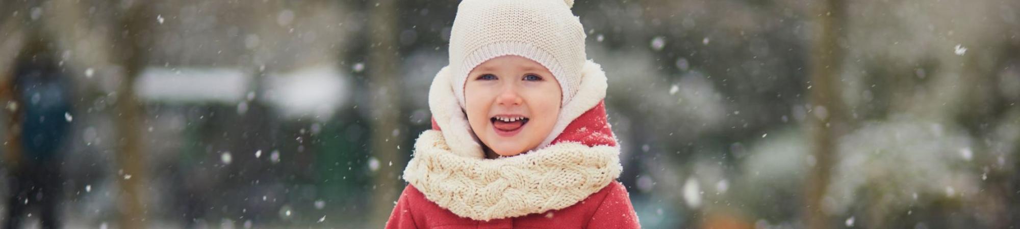 kid in red coat with hat and scarf