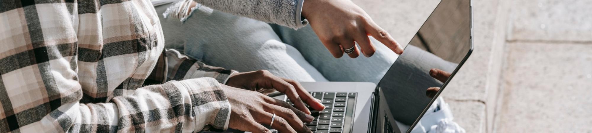 2 people looking up something on computer