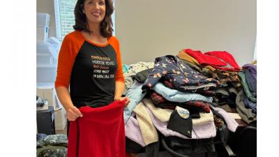 Patricia Huneycutt sorting coats for 2023 UWSC Winter Care Drive