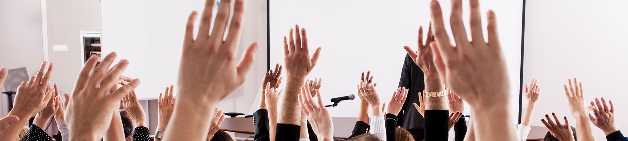 a group of hands raised