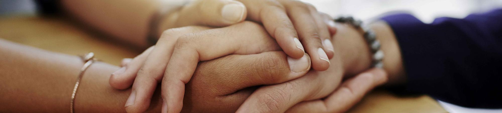 someone holding another's hand in both of theirs